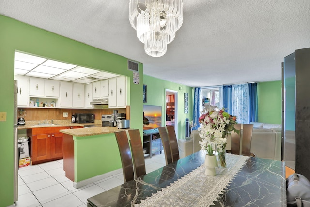 2029 NW 46th Ave Unit E204, Lauderhill, FL 33313 - kitchen with electric range, under cabinet range hood, black microwave, a chandelier, and a sink