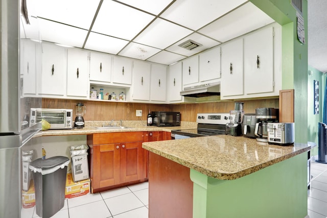 2029 NW 46th Ave Unit E204, Lauderhill, FL 33313 - kitchen with under cabinet range hood, electric stove, light tile patterned floors, a sink, and a drop ceiling