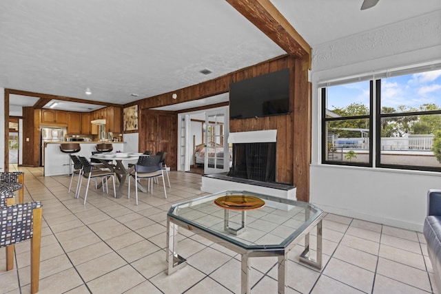 14601 Orange Ave, Fort Pierce, FL 34945 - living room with wooden walls, light tile patterned floors, and a fireplace