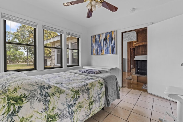 14601 Orange Ave, Fort Pierce, FL 34945 - tiled bedroom with a fireplace and a ceiling fan