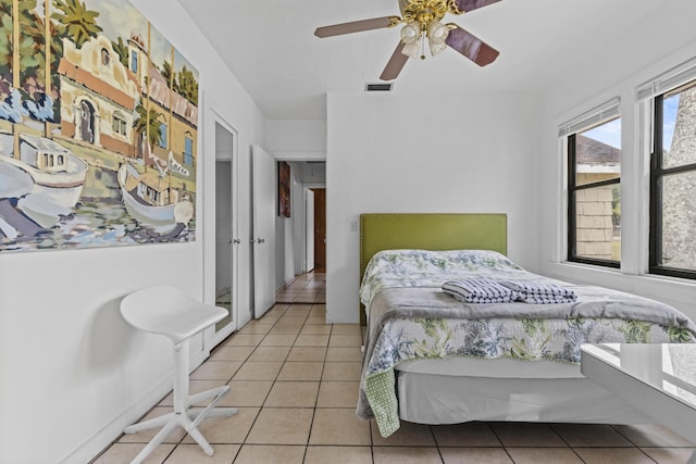 14601 Orange Ave, Fort Pierce, FL 34945 - bedroom with light tile patterned flooring, a ceiling fan, and baseboards