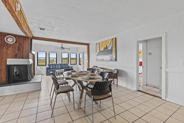 14601 Orange Ave, Fort Pierce, FL 34945 - dining space featuring light tile patterned floors, ceiling fan, and a large fireplace