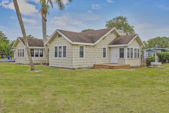 14601 Orange Ave, Fort Pierce, FL 34945 - rear view of house featuring a shingled roof and a lawn