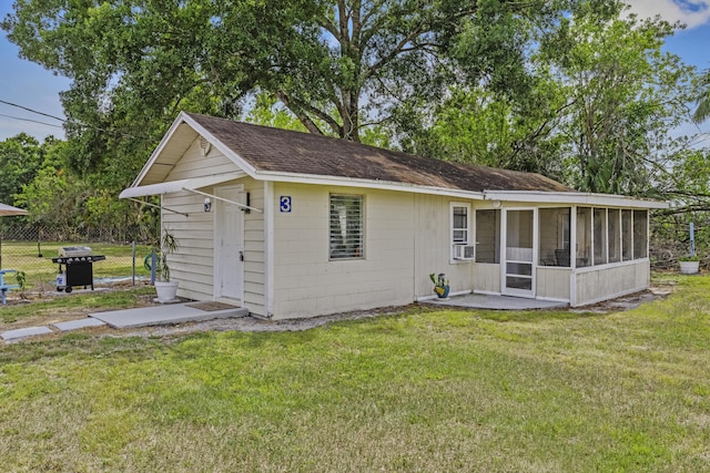 14601 Orange Ave, Fort Pierce, FL 34945 - rear view of property featuring a sunroom, roof with shingles, and cooling unit