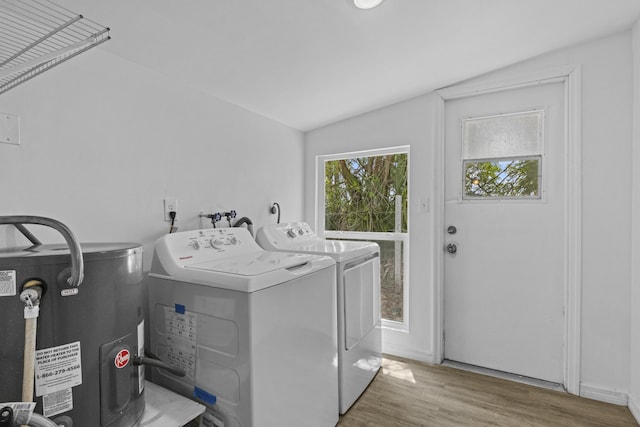 14601 Orange Ave, Fort Pierce, FL 34945 - washroom featuring water heater, separate washer and dryer, and wood finished floors