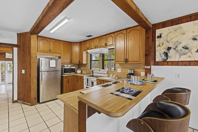 14601 Orange Ave, Fort Pierce, FL 34945 - kitchen featuring appliances with stainless steel finishes, beamed ceiling, healthy amount of natural light, light countertops, and a sink