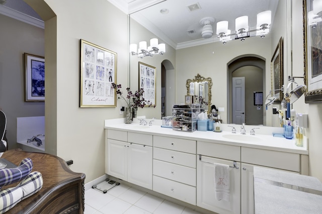 1081 Vintner Blvd, Palm Beach Gardens, FL 33410 - bathroom featuring double vanity, crown molding, tile patterned flooring, and baseboards