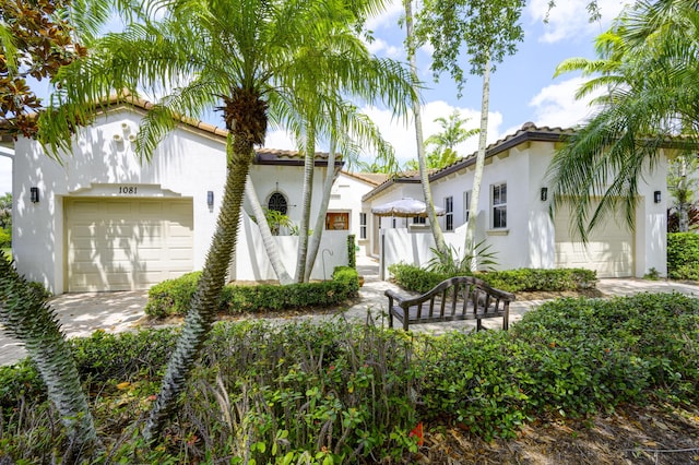 1081 Vintner Blvd, Palm Beach Gardens, FL 33410 - view of front of home featuring stucco siding, a tiled roof, and a garage