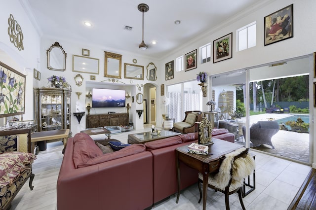 1081 Vintner Blvd, Palm Beach Gardens, FL 33410 - living room featuring crown molding, arched walkways, recessed lighting, and a high ceiling