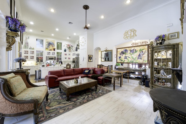 1081 Vintner Blvd, Palm Beach Gardens, FL 33410 - living area featuring crown molding, arched walkways, and recessed lighting