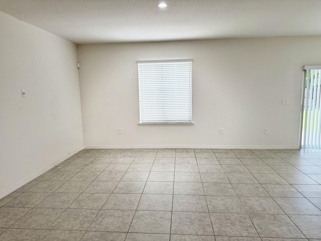 763 SE Evergreen Ter, Port Saint Lucie, FL 34983 - unfurnished room with healthy amount of natural light, light tile patterned flooring, baseboards, and recessed lighting