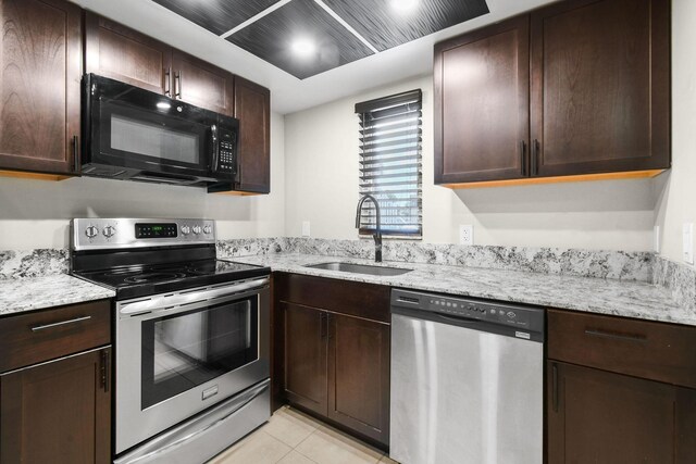 1631 SE Green Acres Cir Unit Bb103, Port Saint Lucie, FL 34952 - kitchen featuring appliances with stainless steel finishes, a sink, and dark brown cabinetry