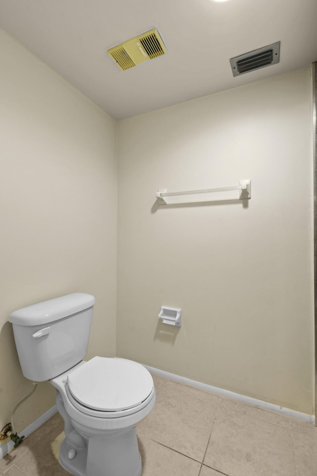 1631 SE Green Acres Cir Unit Bb103, Port Saint Lucie, FL 34952 - bathroom featuring baseboards, toilet, and tile patterned flooring