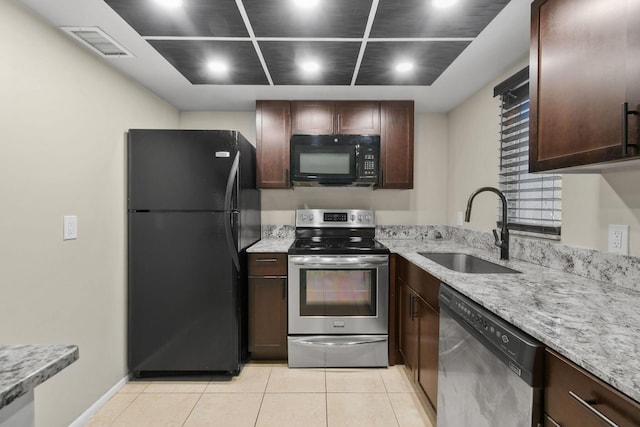1631 SE Green Acres Cir Unit Bb103, Port Saint Lucie, FL 34952 - kitchen featuring black appliances, a sink, light tile patterned floors, light stone countertops, and recessed lighting