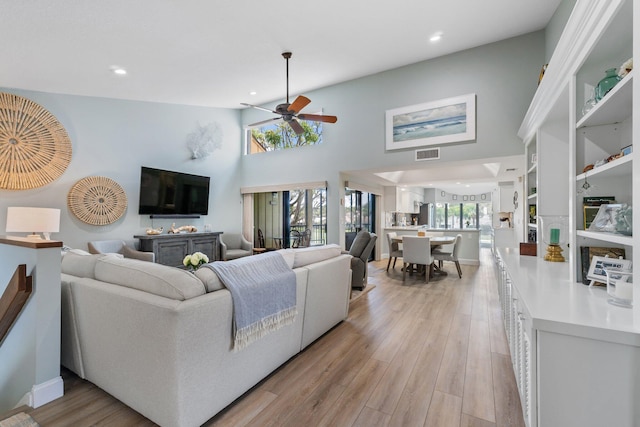 17166 Waterbend Dr Unit 210, Jupiter, FL 33477 - living area with a ceiling fan, recessed lighting, light wood finished floors, and a high ceiling