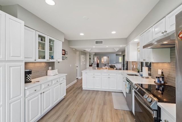 17166 Waterbend Dr Unit 210, Jupiter, FL 33477 - kitchen featuring stainless steel appliances, under cabinet range hood, a peninsula, decorative backsplash, and light countertops