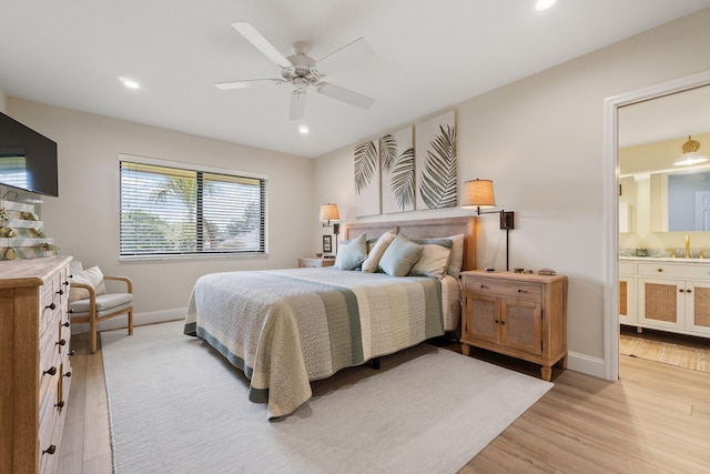 17166 Waterbend Dr Unit 210, Jupiter, FL 33477 - bedroom with light wood finished floors, a sink, baseboards, recessed lighting, and ensuite bath