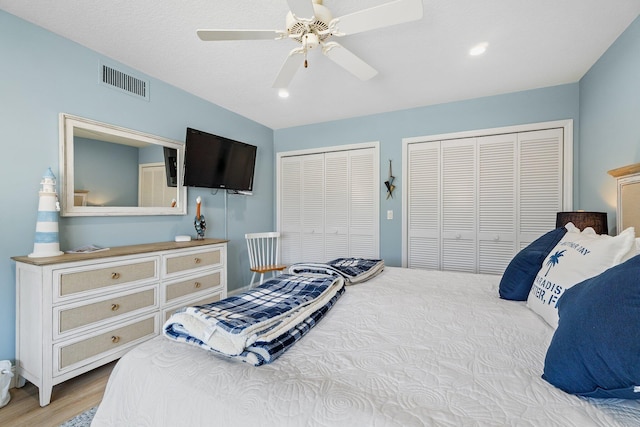 17166 Waterbend Dr Unit 210, Jupiter, FL 33477 - bedroom with multiple closets, wood finished floors, recessed lighting, and a ceiling fan