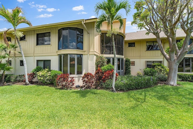 17166 Waterbend Dr Unit 210, Jupiter, FL 33477 - rear view of property with a yard and stucco siding