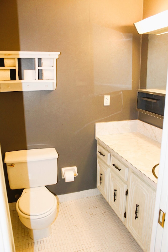 540 High Point Dr Unit A, Delray Beach, FL 33445 - half bathroom featuring toilet, vanity, and tile patterned flooring
