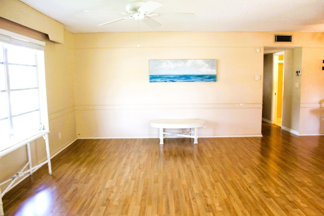 540 High Point Dr Unit A, Delray Beach, FL 33445 - empty room featuring wood finished floors, plenty of natural light, a ceiling fan, and baseboards