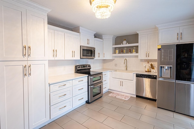 1515 Augusta Cir Unit 116, Delray Beach, FL 33445 - kitchen featuring appliances with stainless steel finishes, open shelves, a sink, light countertops, and tasteful backsplash