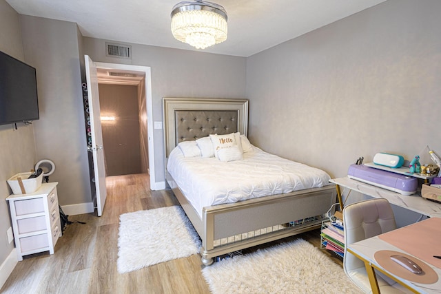 1515 Augusta Cir Unit 116, Delray Beach, FL 33445 - bedroom with wood finished floors, a chandelier, and baseboards