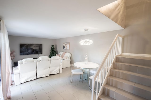1515 Augusta Cir Unit 116, Delray Beach, FL 33445 - living room featuring a chandelier, stairs, tile patterned floors, and baseboards