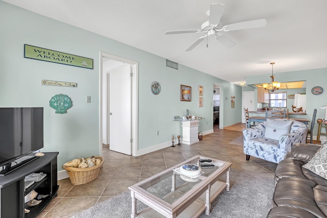 7430 S Ocean Dr Unit 319, Jensen Beach, FL 34957 - tiled living room with a ceiling fan and a chandelier