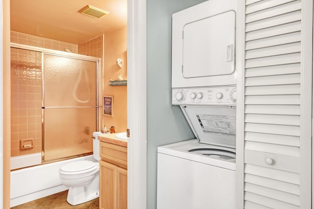 7430 S Ocean Dr Unit 319, Jensen Beach, FL 34957 - laundry room with stacked washer / dryer and tile patterned flooring
