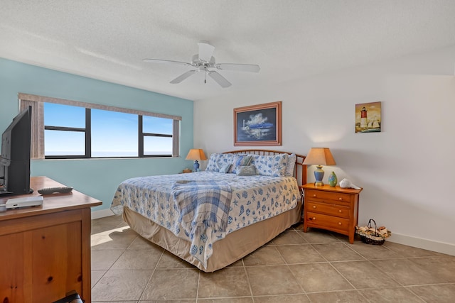 7430 S Ocean Dr Unit 319, Jensen Beach, FL 34957 - bedroom with baseboards, light tile patterned flooring, and ceiling fan