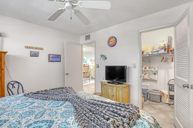 7430 S Ocean Dr Unit 319, Jensen Beach, FL 34957 - bedroom with a ceiling fan, light tile patterned flooring, and a walk in closet