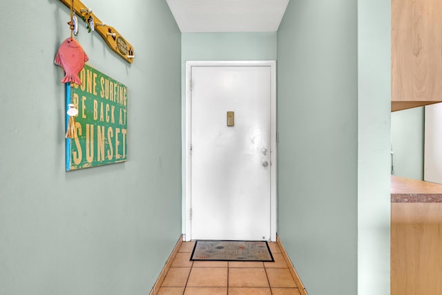 7430 S Ocean Dr Unit 319, Jensen Beach, FL 34957 - doorway with baseboards and light tile patterned flooring