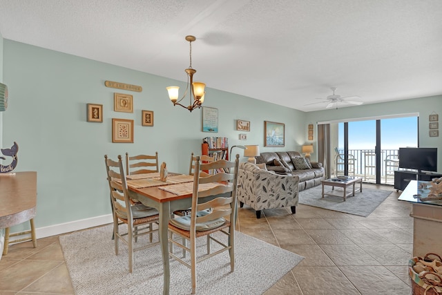 7430 S Ocean Dr Unit 319, Jensen Beach, FL 34957 - dining room with a ceiling fan, a chandelier, and a textured ceiling