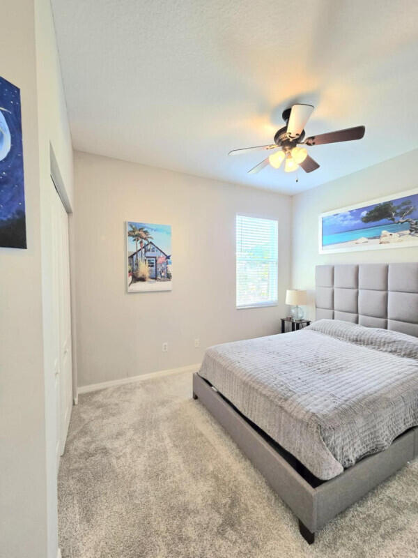 9658 SW Lindale Trace Blvd, Port Saint Lucie, FL 34987 - bedroom featuring carpet flooring, baseboards, and ceiling fan