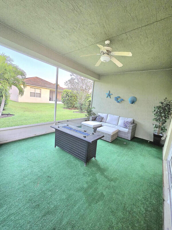 9658 SW Lindale Trace Blvd, Port Saint Lucie, FL 34987 - living room with carpet flooring and ceiling fan