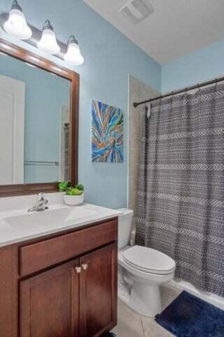 1102 Brinely Pl, Royal Palm Beach, FL 33411 - bathroom featuring tile patterned flooring, vanity, toilet, and a shower with shower curtain