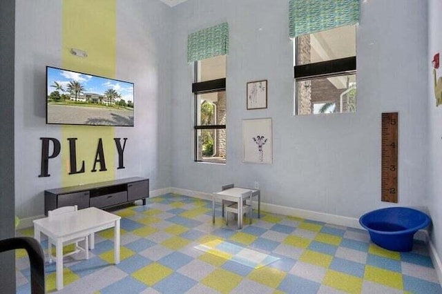1102 Brinely Pl, Royal Palm Beach, FL 33411 - rec room featuring a high ceiling and baseboards