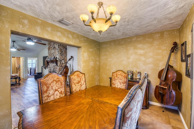 11033 67th Pl N, The Acreage, FL 33412 - dining area featuring a chandelier, baseboards, lofted ceiling, ceiling fan, and a textured wall