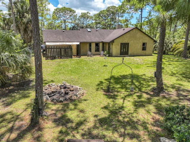 11033 67th Pl N, The Acreage, FL 33412 - back of property with a chimney, a yard, and stucco siding