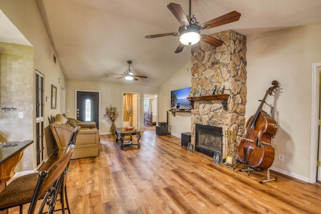11033 67th Pl N, The Acreage, FL 33412 - living room featuring lofted ceiling, ceiling fan, wood finished floors, baseboards, and a textured ceiling