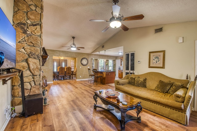 11033 67th Pl N, The Acreage, FL 33412 - living room featuring a ceiling fan, wood finished floors, a textured ceiling, vaulted ceiling, and baseboards