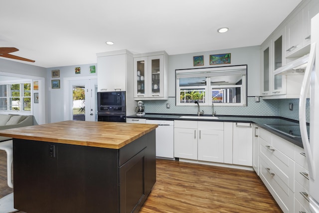 149 SW Grimaldo Ter, Port Saint Lucie, FL 34984 - kitchen with black appliances, a sink, wooden counters, decorative backsplash, and recessed lighting