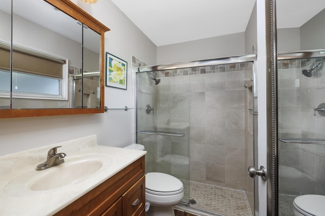 149 SW Grimaldo Ter, Port Saint Lucie, FL 34984 - bathroom featuring toilet, vanity, and a shower stall