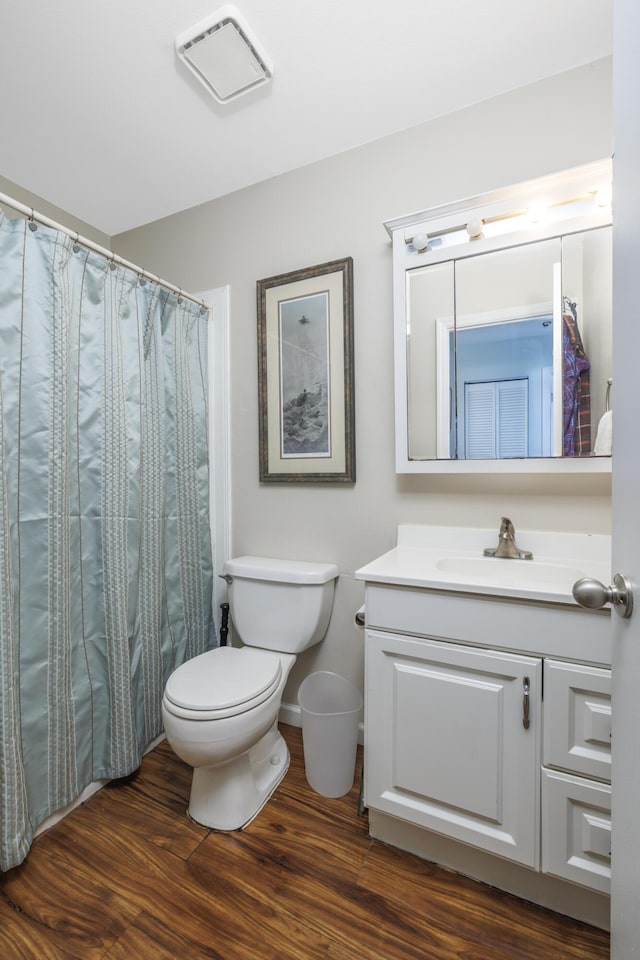 149 SW Grimaldo Ter, Port Saint Lucie, FL 34984 - bathroom with vanity, toilet, and wood finished floors