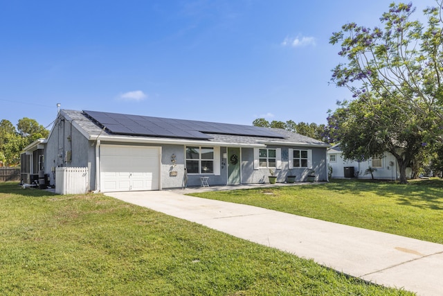 149 SW Grimaldo Ter, Port Saint Lucie, FL 34984 - ranch-style home with a garage, a front lawn, roof mounted solar panels, and concrete driveway