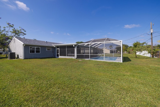 149 SW Grimaldo Ter, Port Saint Lucie, FL 34984 - back of house with cooling unit, a lawn, stucco siding, a lanai, and a sunroom