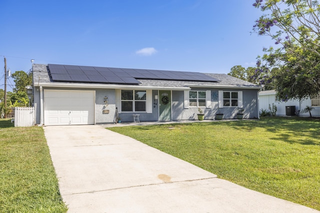 149 SW Grimaldo Ter, Port Saint Lucie, FL 34984 - single story home featuring concrete driveway, an attached garage, central AC, roof mounted solar panels, and a front yard