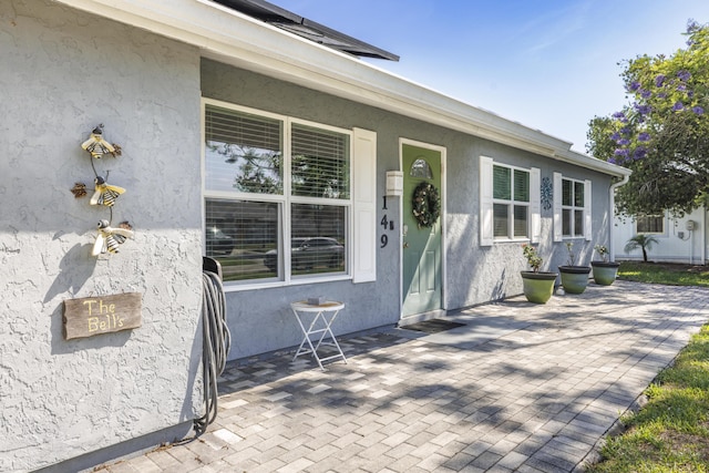 149 SW Grimaldo Ter, Port Saint Lucie, FL 34984 - property entrance featuring stucco siding and a porch