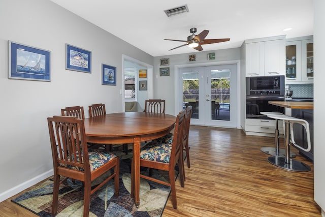 149 SW Grimaldo Ter, Port Saint Lucie, FL 34984 - dining space with french doors, light wood finished floors, ceiling fan, and baseboards